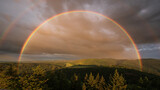 Fototapeta Tęcza - Dreamlike rainbow after a summer thunderstorm shortly before the sun goes down