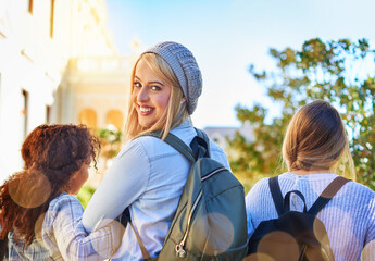Poster - Places to go, futures to build. Rearview shot of university students walking to class on campus.