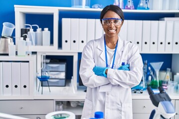 young african american woman scientist smiling confident standing with arms crossed gesture at labor