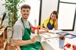© Krakenimages.com - Young hispanic artist couple smiling happy drawing at art studio. Man holding diploma sitting on the table.
