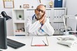 © Krakenimages.com - Mature doctor man at the clinic sleeping tired dreaming and posing with hands together while smiling with closed eyes.