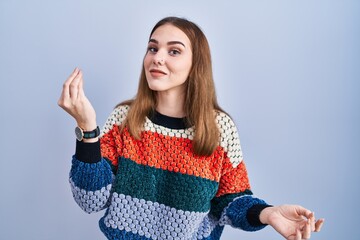 Sticker - Young hispanic girl standing over blue background doing italian gesture with hand and fingers confident expression