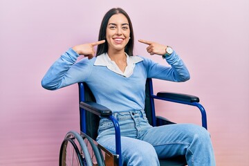 Sticker - Beautiful woman with blue eyes sitting on wheelchair smiling cheerful showing and pointing with fingers teeth and mouth. dental health concept.