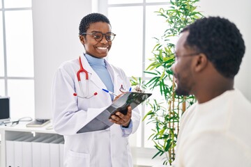 Poster - Man and woman doctor and patient having medical consultation speaking at clinic