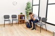 © Krakenimages.com - Young hispanic man desperate sitting on chair at waiting room