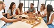 © Krakenimages.com - Group of young people smiling happy eating italian pizza sitting on the table at home