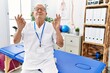 © Krakenimages.com - Senior physiotherapy man working at pain recovery clinic relax and smiling with eyes closed doing meditation gesture with fingers. yoga concept.