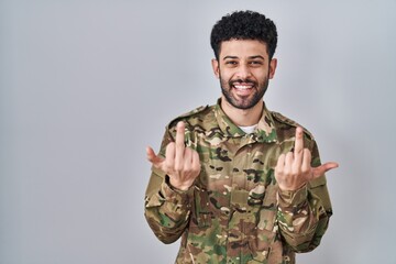 Canvas Print - Arab man wearing camouflage army uniform showing middle finger doing fuck you bad expression, provocation and rude attitude. screaming excited