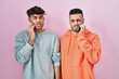 © Krakenimages.com - Young hispanic gay couple standing over pink background touching mouth with hand with painful expression because of toothache or dental illness on teeth. dentist