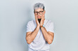 © Krakenimages.com - Young hispanic man with modern dyed hair wearing white t shirt and glasses tired hands covering face, depression and sadness, upset and irritated for problem
