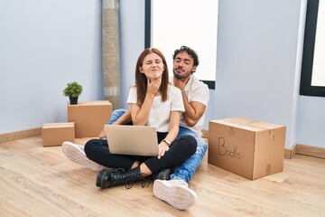 Poster - Young couple using laptop at new home touching painful neck, sore throat for flu, clod and infection