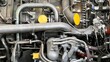 © vesperstock - Details of jet aircraft engine with bright yellow caps on some ports