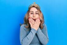 Middle Age Caucasian Woman Wearing Queen Crown Shocked Covering Mouth With Hands For Mistake. Secret Concept.