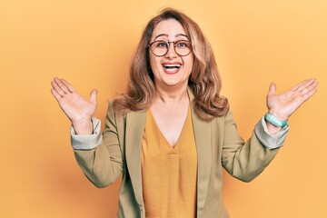 Poster - Middle age caucasian woman wearing casual clothes celebrating victory with happy smile and winner expression with raised hands