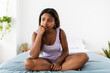 © Xavier Lorenzo - Depressed teenager girl thinking while sitting on bed - Young hispanic latina woman feeling sad while resting on bedroom - Negative emotions and bad feelings concept