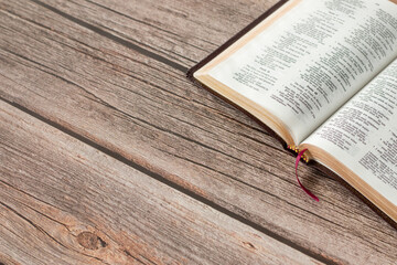 Wall Mural - Open Holy Bible Book with golden pages on a rustic wooden table with copy space. Studying the Scriptures inspired by God Jesus Christ, Christian biblical concept.