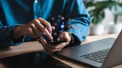 Social media and digital online concepts young man using smartphone with social media Holiday living and social media social distancing concept Work from home