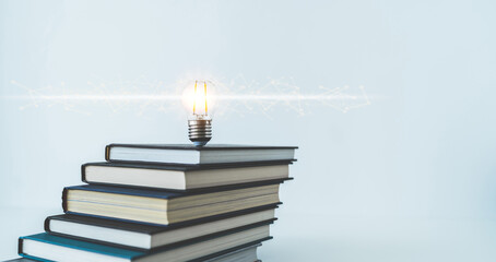 Glowing lightbulb or bright lamp with book or textbook. Skill improvement for student or businessperson. Studying and training course online at home. Business success idea, education learning concept