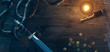 A Pirate's Cutlass Sword And Pirate Elements On A Desk At Night. 3D Rendering, Illustration