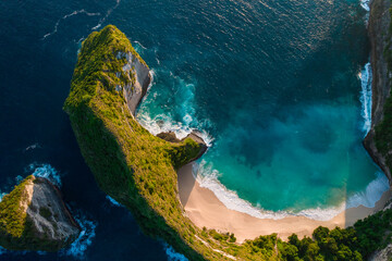 Wall Mural - Aerial drone top view shot of rocky beach with cliff. Indian ocean shore. Copy space for text. Nature and travel background. Beautiful natural summer vacation travel concept. Waves and sand.
