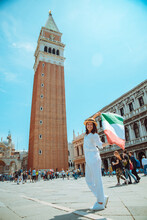 Woman With Italian Flag In The Center Of Venice Square Bell Tower On Background