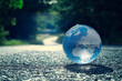 Erdball - Strasse - Ecology - Earth - Lensball - High quality photo - Bioeconomy - A closeup of lensball with reflection planet on ground