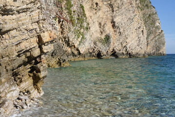 rocks in the sea.Rock rocks above the sea. Huge rock rocks with plant surface over Mediterranean blue sea