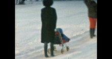 Funny Mother With Baby In Pram Walks In Snowy Forest Path. Happy Woman With Small Child Walking Among Park Trees. Winter Family Life Outdoors. Vintage Color Film. Family Archive. Retro 1980s. 4k