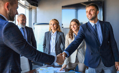 Poster - Business people shaking hands, finishing up a meeting.