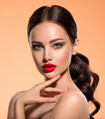 Wall Mural - stunning brunette girl with long black hair. beautiful white girl with a red lipstick on lips. close