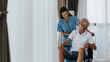 © sarayutsridee - Young asian nurse helping senior man at home. Elderly man sitting on wheelchair and talking with young docter in house. Senior health care.
