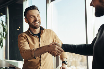Poster - Business partnership. Smiling male entrepreneurs shaking hands, celebrating cooperation agreement at office