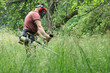 © Wojciech Boruch - a person mows the grass with a petrol brushcutter