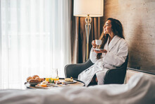 Woman Eating Breakfast In The Hotel Room. Room Service Breakfast In Hotel Room.