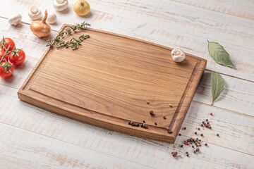 Wall Mural - square wooden cutting board with edging. cherry tomatoes and spices on a white background. mockup with copy space for text, side view