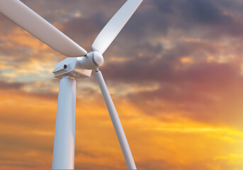 Wind power plant. Electricity generator close up. Windmill at sunset. Green energy generator. Fragment of turbine for renewable energy. Concept energy security. Wind turbine blades. Selective focus