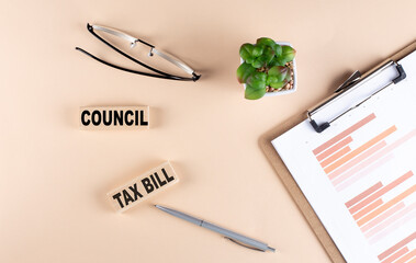 Poster - COUNCIL TAX BILL text on wooden block with chart and glasses, business concept