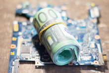 Money Banknotes On The Motherboard. Increase In Prices Due To The War In Ukraine