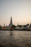 Fototapeta Koty - The view of the famous temple called Wat Arun located next to the grand river called chao Phraya in Bangkok city , Thailand. 