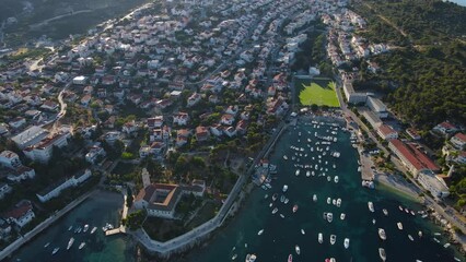 Wall Mural - Aerial view of the old town of Hvar with football arena on Adriatic sea, Croatia, Europe. Drone 4k video. Summer vacation destination
