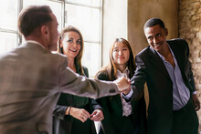 A Group Of Young Multi-ethnic Entrepreneurs Shaking Hands During A Working Business - Business Lifestyle Concept, International Trade Agreement