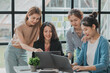 © kamiphotos - A group of young Asian business women stand and talk. Jointly open a startup company and a business plan management plan to grow the business and be profitable by the concept of the new generation.