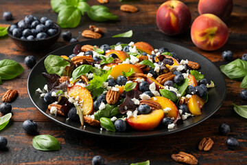Wall Mural - Peach, blueberry salad with vegetables, feta cheese and pecan nuts. Healthy summer food