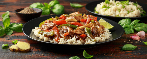 Stir fry pepper chicken with sweet peppers, onion, garlic and ginger