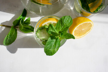 Wall Mural - Water with lemon, cucumber, mint on a light background