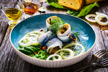 Wall Mural - Marinated herring fillets with pickled cucumber, dill and  onion on wooden table
