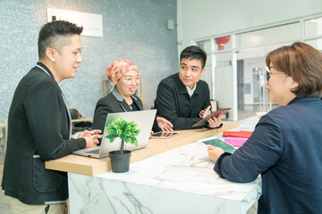 Business work colleagues having a meeting in a co working share space.