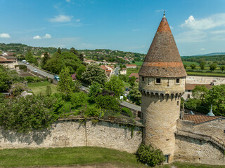 Circular defensive tower with loopholes piercing the town walls of Cluny protecting the ancient religious center and abbey