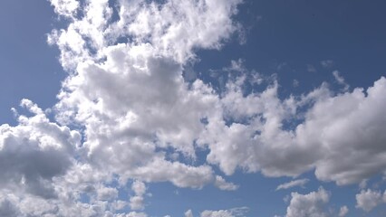 Wall Mural - cloud and blue sky timelape of dramatic fast moving white clouds on beautiful sunny blue sky