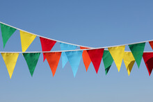 Buntings With Colorful Triangular Flags Against Blue Sky